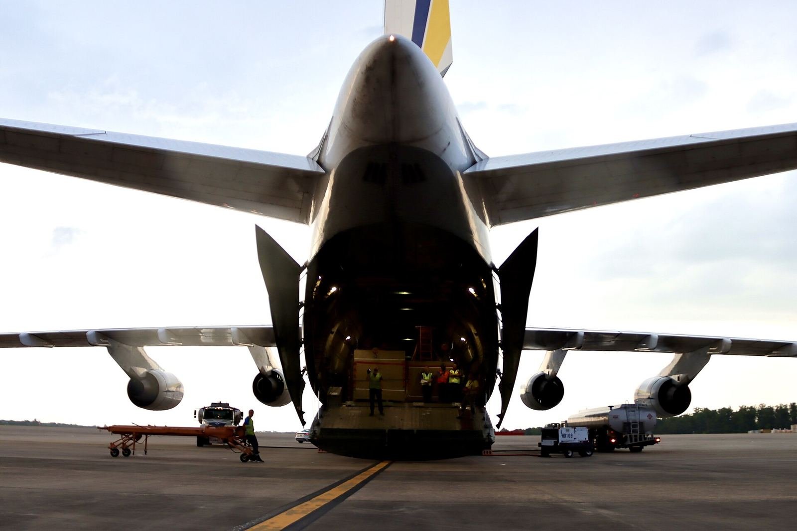 Cargo aircraft with its nose door open for loading on the apron